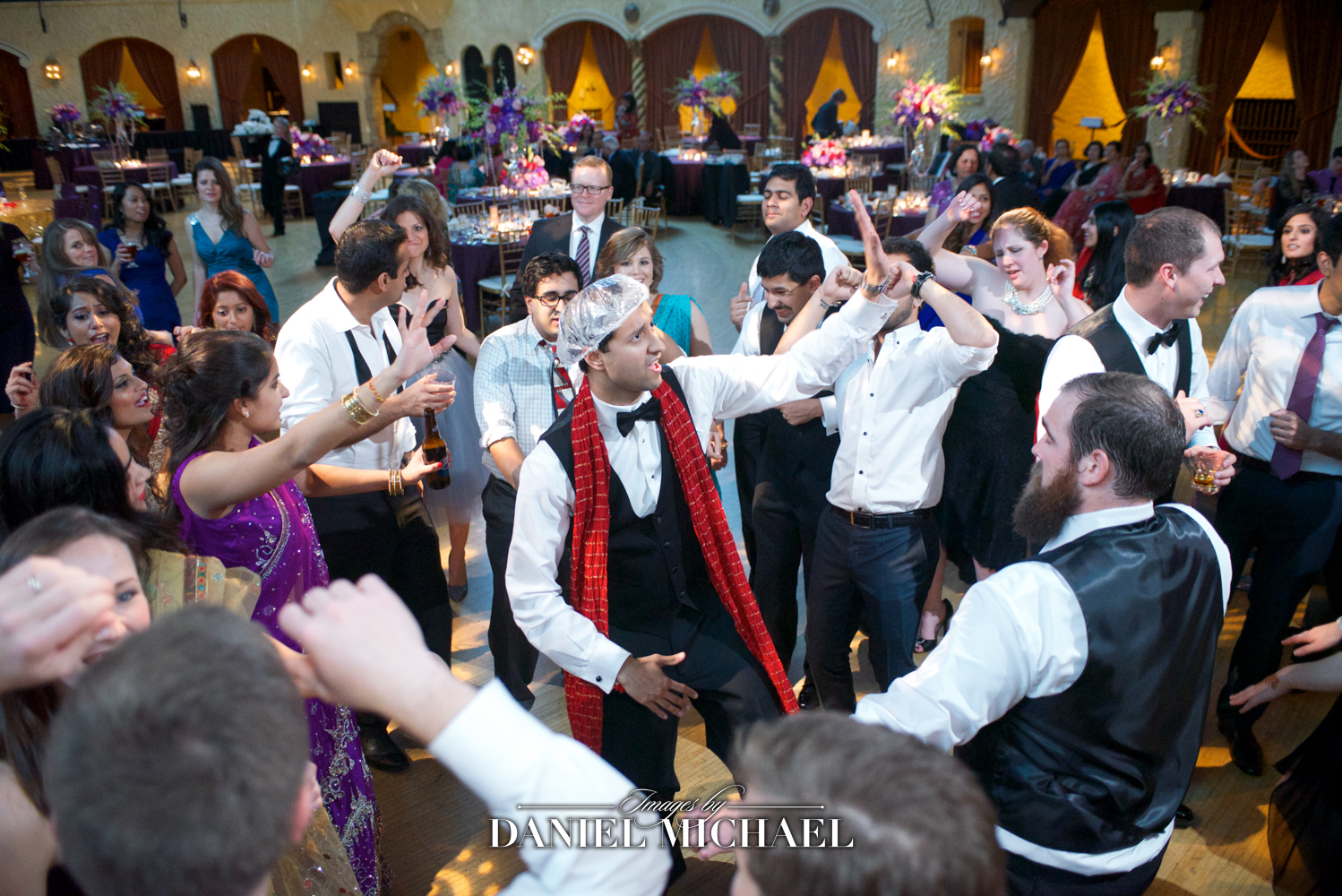 Candid photography by a South Asian wedding photographer during a lively reception